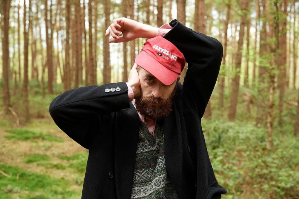 Jerskin Fendrix poses for a photoshoot in a forest