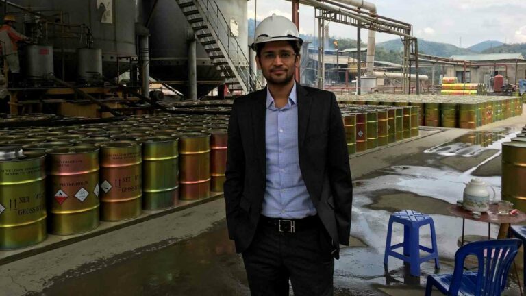 A man wearing a suit and white safety helmet