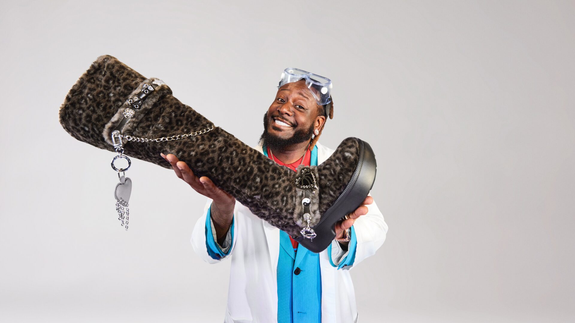 Rapper T-Pain with Crocs' new Classic Unforgettable Leopard Knee High Boot as a nod to his lyrics "boots with the fur"