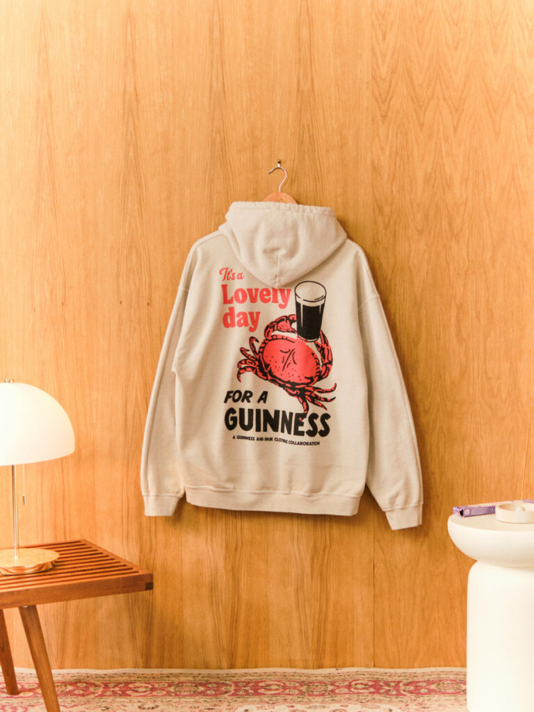 An off-white hoodie featuring a crab print from the UN:IK collaboration with Guinness