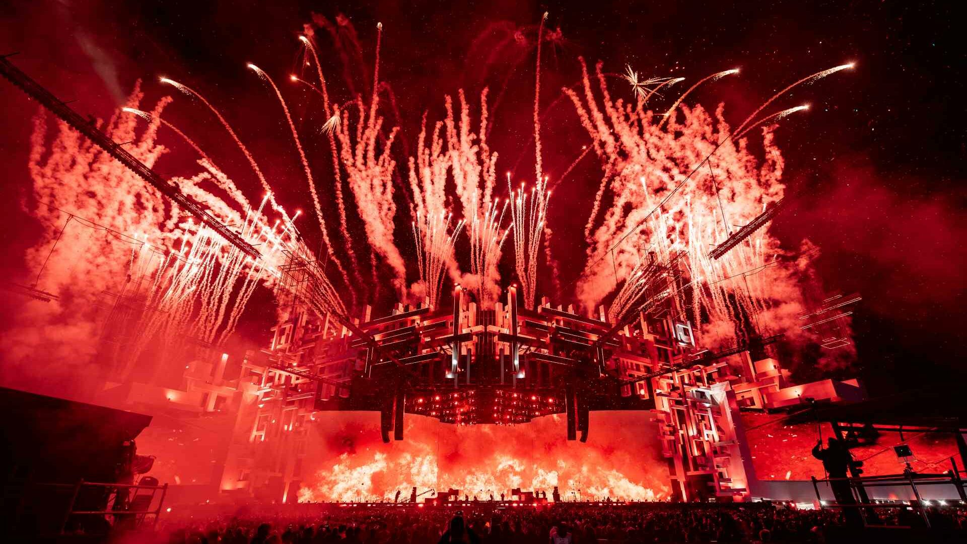 Fireworks exploding over a large dance stage at soundstorm