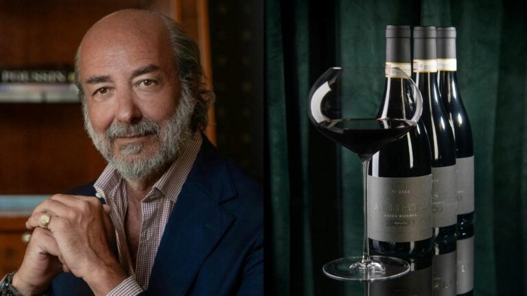 Composite of a smiling man and three bottles of red with a red wine glass