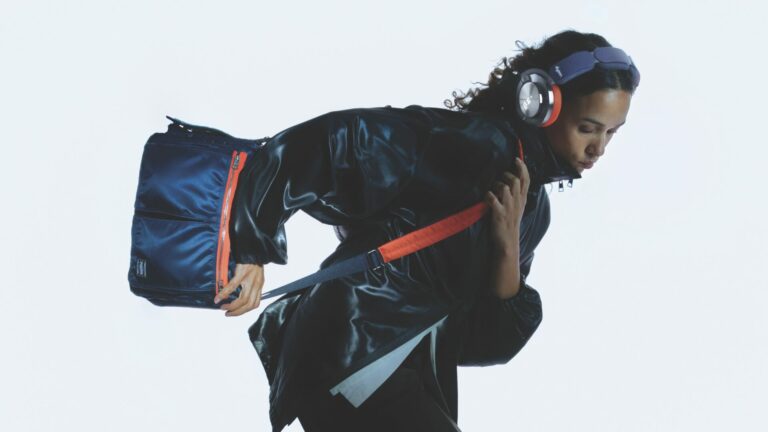 A lifestyle shot of a model wearing the Dyson and PORTER OnTrack headphones collaboration