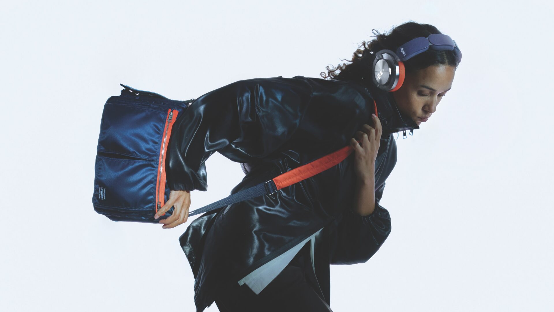 A lifestyle shot of a model wearing the Dyson and PORTER OnTrack headphones collaboration