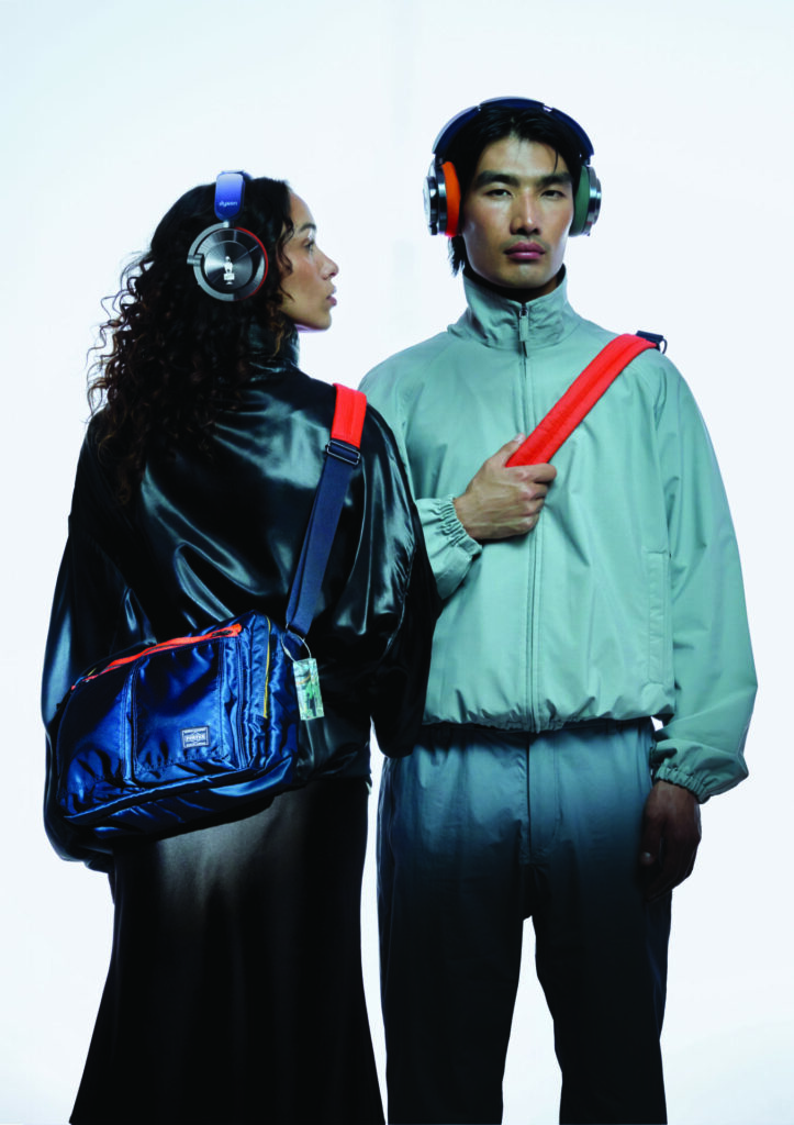 A lifestyle shot of two models wearing the Dyson and PORTER OnTrack headphones collaboration