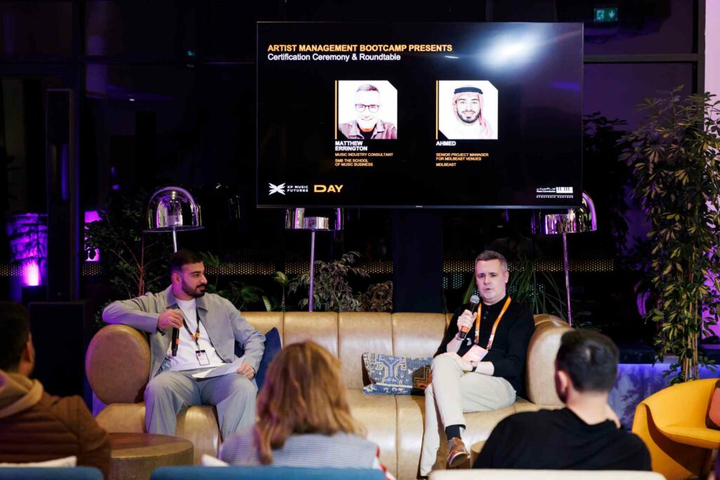 A group of people having a group chat on sofas at Riyadh Music Week 2025