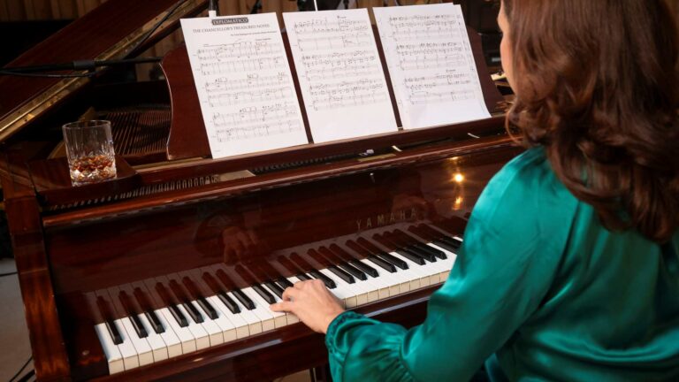 A woman playing music at a piano