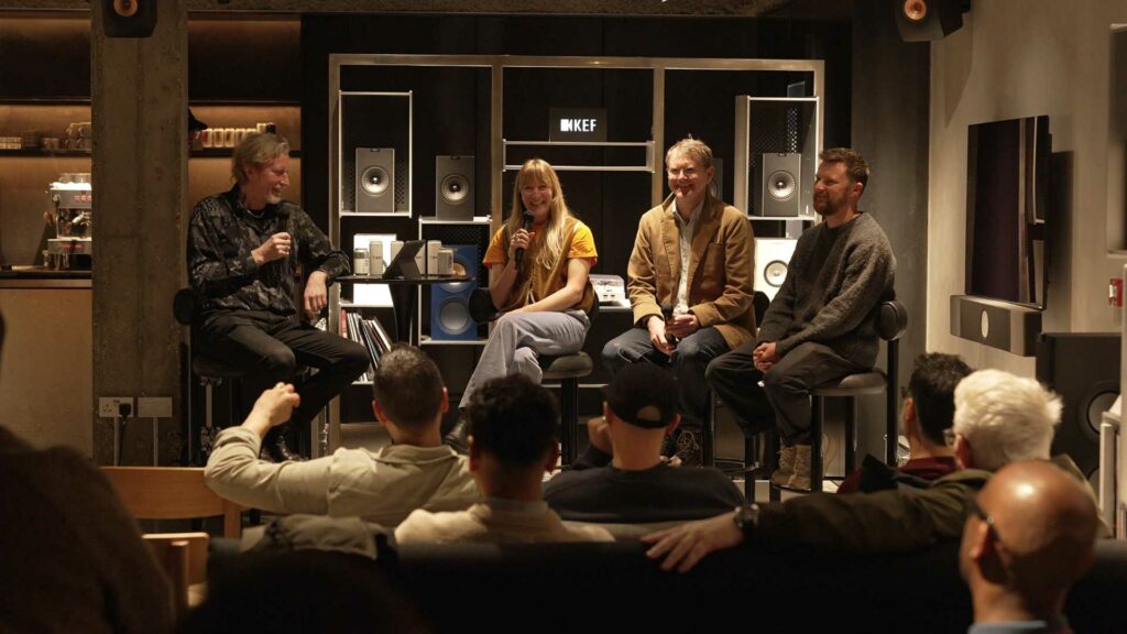 Panellists at the KEF & Flashback Records: The Resurgence of Vinyl event, photographed in conversation at KEF Music Gallery London, with KEF speakers displayed on shelving behind them.