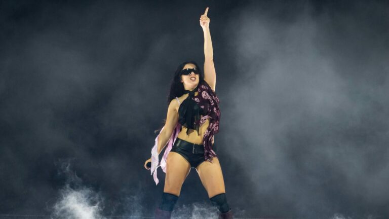 Charli xcx wearing McQueen skull scarf on the brat tour