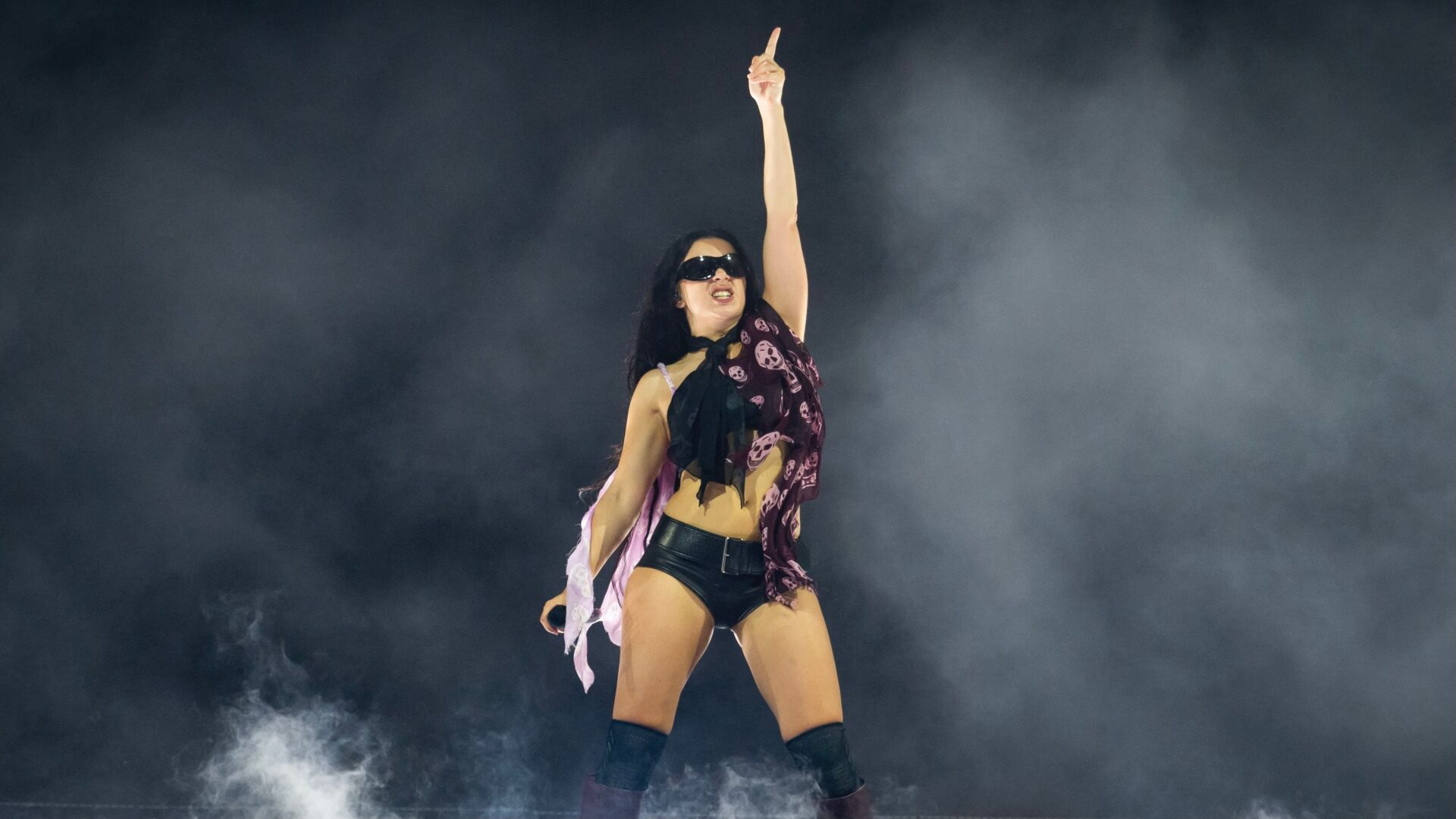 Charli xcx wearing McQueen skull scarf on the brat tour
